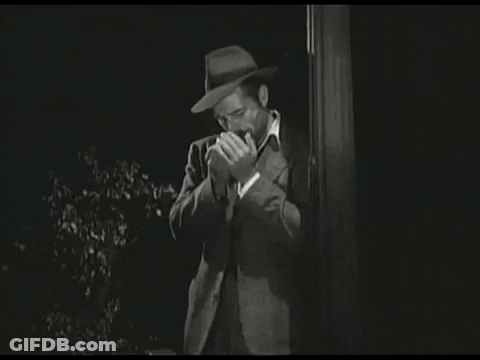 Man In Hat Covering Mouth Black And White GIF