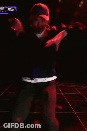 Man In Hat Dancing On Stage With Chinese Writing GIF