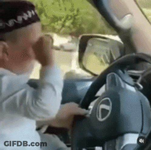 Man In Hat Driving Car Talking On Phone GIF