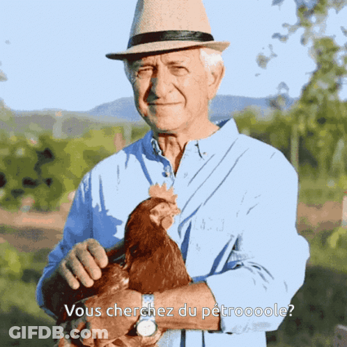Man In Hat Holding Chicken Vous Cherchez Du Petroooole GIF