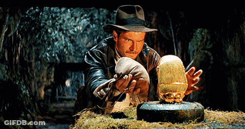 Man In Hat Holding Gold Object GIF