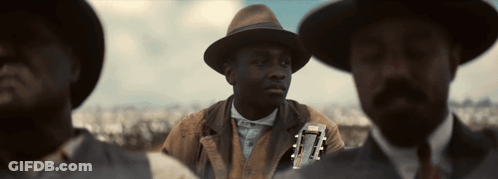 Man In Hat Holding Guitar Next To Two Men GIF