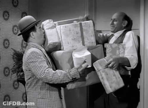 Man In Hat Holding Stack Of Gifts GIF
