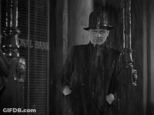Man In Hat In Rain At National Bank GIF
