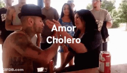 Man In Hat Kissing Woman On Forehead While Group Watches GIF