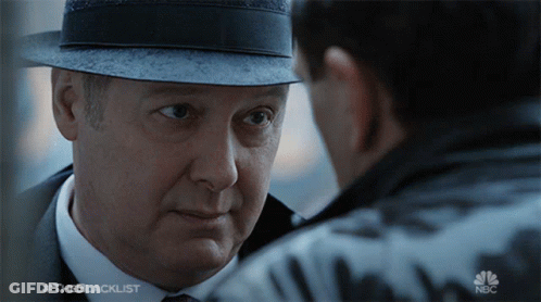 Man In Hat Looking At Man In Suit And Tie Blacklist GIF