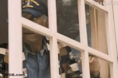Man In Hat Looking Out Window GIF