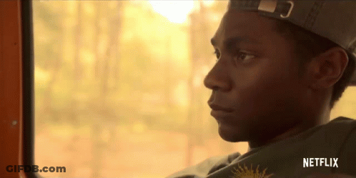 Man In Hat Looking Out Window With Netflix Logo GIF