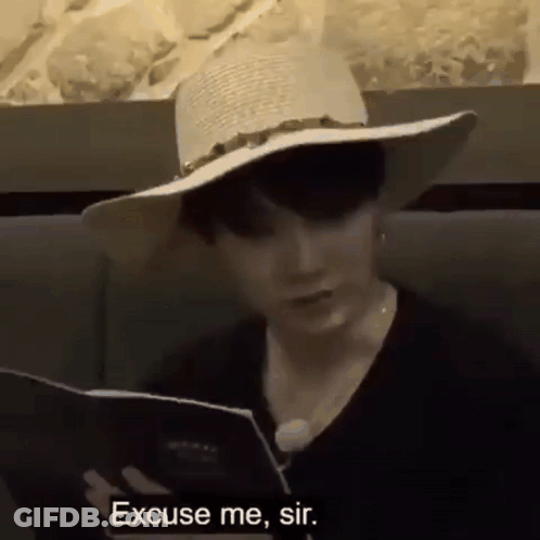 Man In Hat Reading Menu GIF