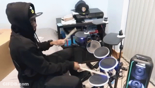 Man In Hat Saying T-II Plays Drum Set GIF