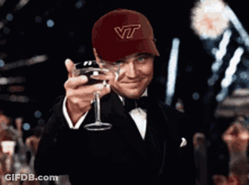 Man In Hat Saying VT Holding Wine Glass GIF