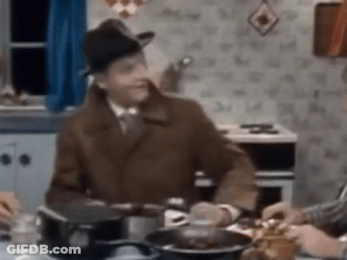 Man In Hat Sitting At Table GIF