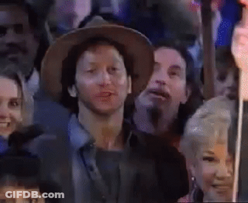 Man In Hat Sitting In Crowd GIF