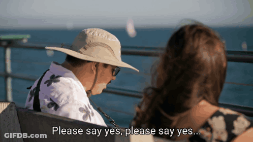 Man In Hat Sitting Next To Woman Saying Please Say Yes GIF