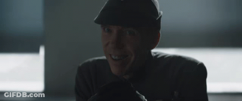 Man In Hat Smiling In Dark Room GIF