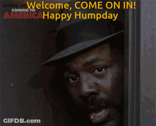 Man In Hat Smiling In Front Of Welcome Come On In Sign GIF