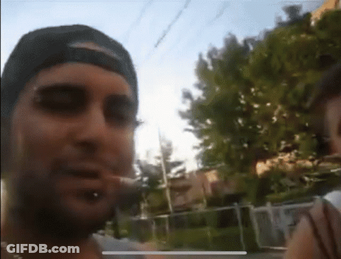 Man In Hat Smoking Cigarette Blurry Photo GIF