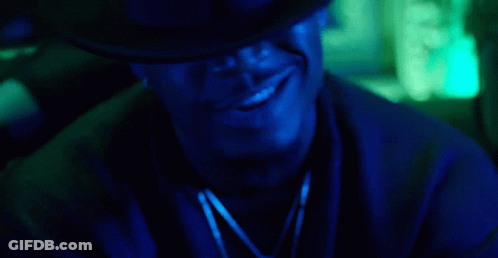 Man In Hat Smoking Cigarette In Dark Room With Blue Light GIF