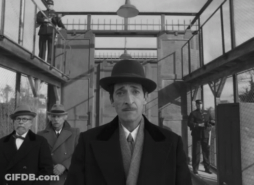 Man In Hat Standing Before Group GIF