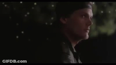 Man In Hat Standing In Dark Looking GIF