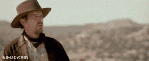 Man In Hat Standing In Desert GIF
