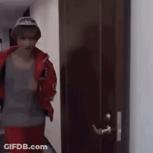 Man In Hat Standing In Front Of Door GIF