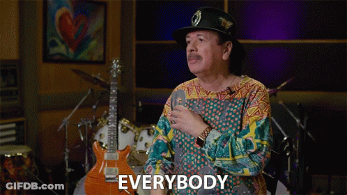 Man In Hat Standing In Front Of Drum Set GIF