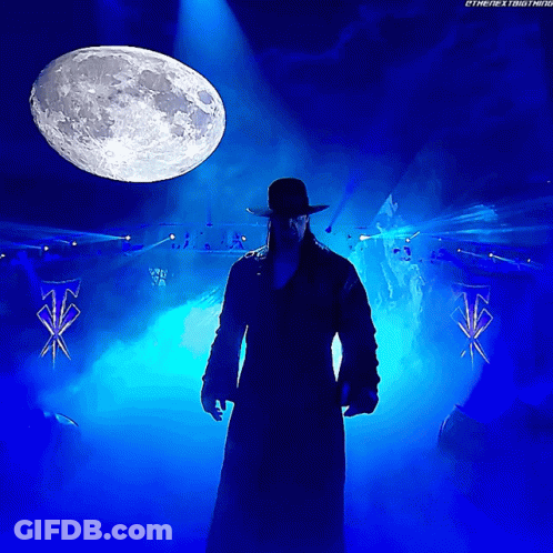 Man In Hat Standing In Front Of Full Moon GIF