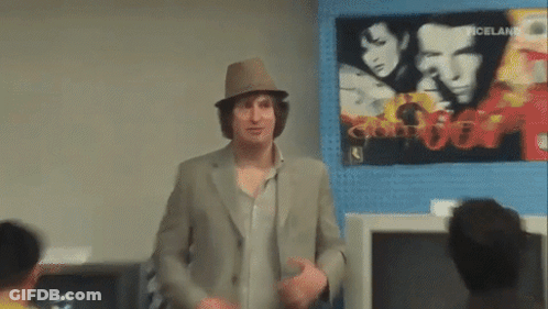 Man In Hat Standing In Front Of Iceland Poster GIF