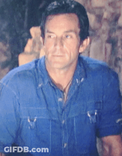 Man In Hat Standing In Front Of That's An Entrance Sign GIF