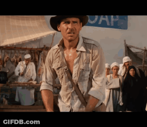 Man In Hat Standing In Front Of UAP Sign GIF