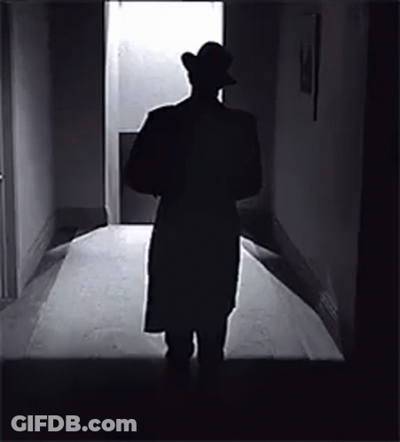 Man In Hat Standing In Hallway GIF