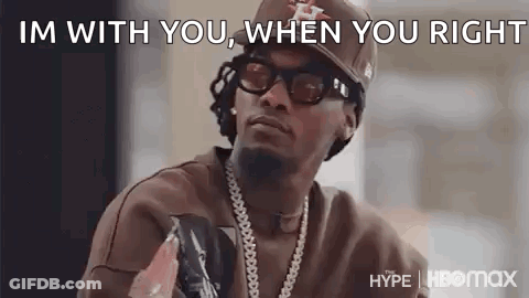 Man In Hat Sunglasses And Necklace Talking GIF