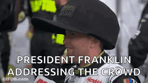 Man In Hat Talking Into Microphone Addressing Crowd GIF