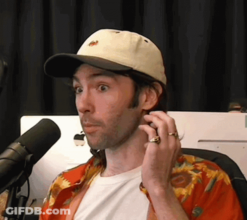 Man In Hat Talking Into Microphone GIF