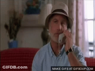 Man In Hat Talking On Phone Sitting On Couch GIF