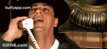 Man In Hat Talking On Phone GIF