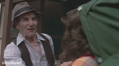 Man In Hat Talking To Man Outside House GIF