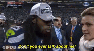 Man In Hat Talking To Woman In Crowd GIF