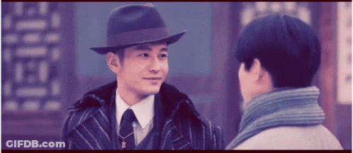 Man In Hat Talks To Man In Suit GIF