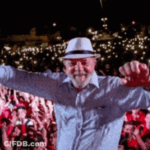 Man In Hat With Arms Outstretched Before Crowd GIF