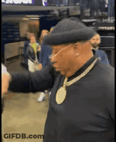 Man In Hat With Gold Medal Necklace GIF