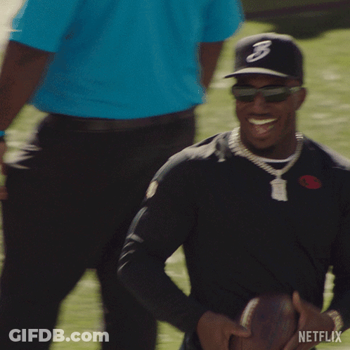 Man In Hat With Letter B Holding Football GIF
