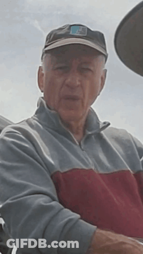 Man In Hat With Letter F Looking At Camera GIF