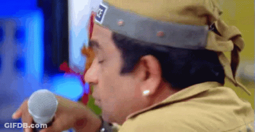 Man In Hat With Letter G Holding Microphone GIF