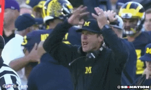 Man In Hat With Letter M In Crowd GIF