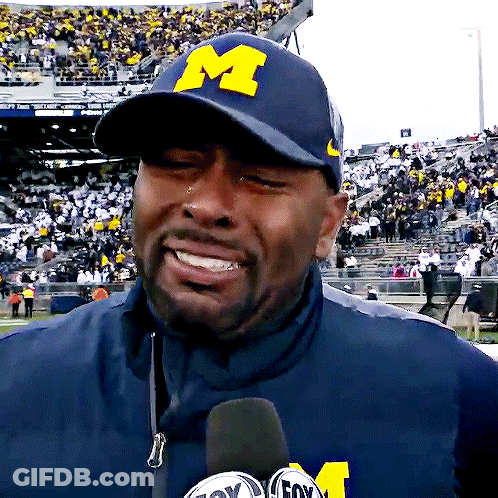Man In Hat With Letter M Talking Into Microphone GIF