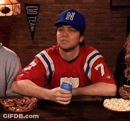 Man In Hat With Letter N Sitting At Table GIF