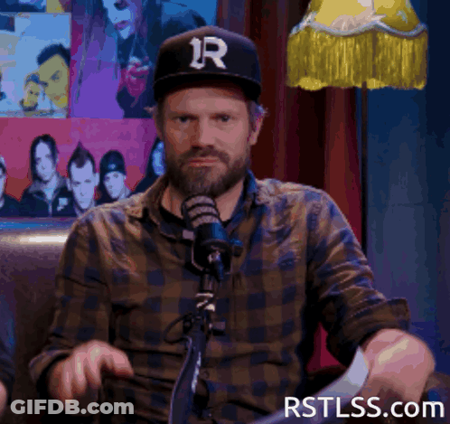 Man In Hat With Letter R At Microphone GIF
