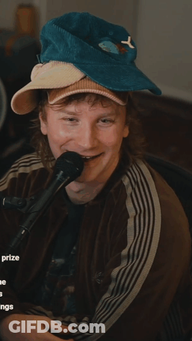 Man In Hat With Letter Y Holding Microphone GIF